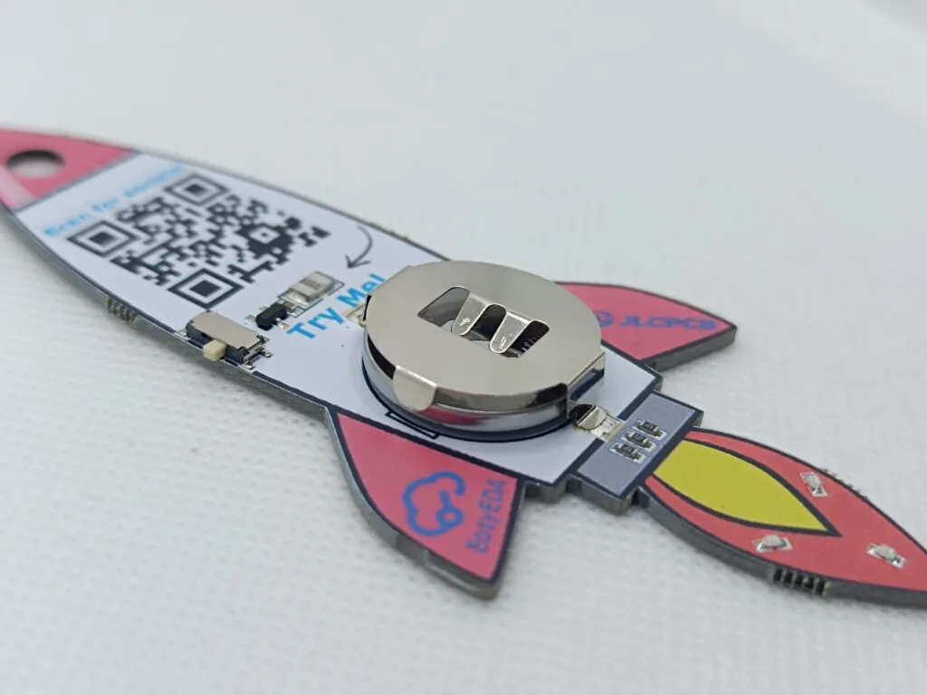 Back of the rocket PCB keychain with battery holder