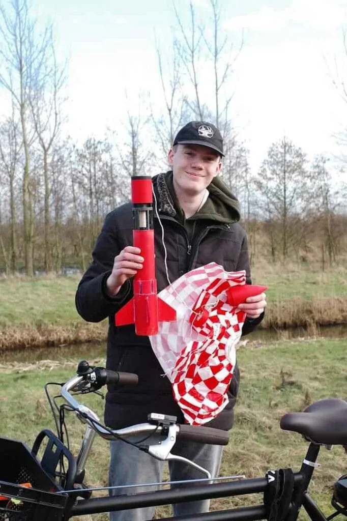 Youp outdoors holding one of his model rockets